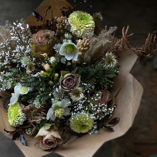 A festive bouquet featuring classic earth tones of winter.