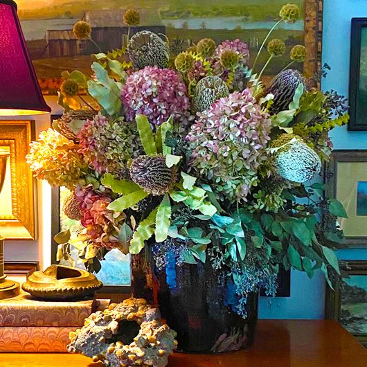 Arrangement featuring Hydrangea, Scabiosa pods and assorted greenery.