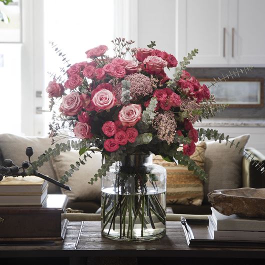 Assorted rose arrangement featuring rice flower, Limonium and Eucalyptus.