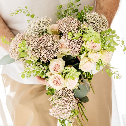 Freeform, hand-tied bouquet featuring 'Victoria Pink®' and 'Victoria White®' rice flower, spray roses and Lepidium.