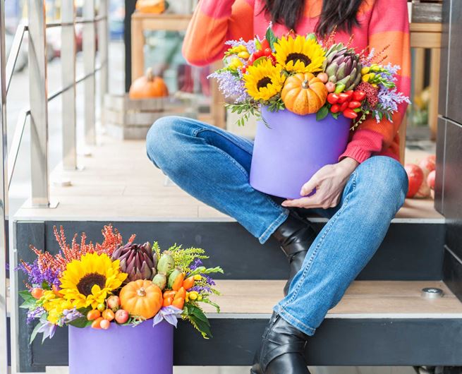 A whimsical hat box arrangement featuring fall blooms.