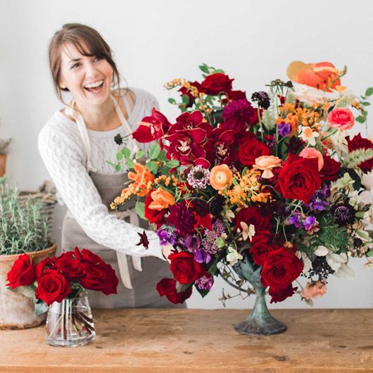 Floral designer arranging bold, beautiful blooms.