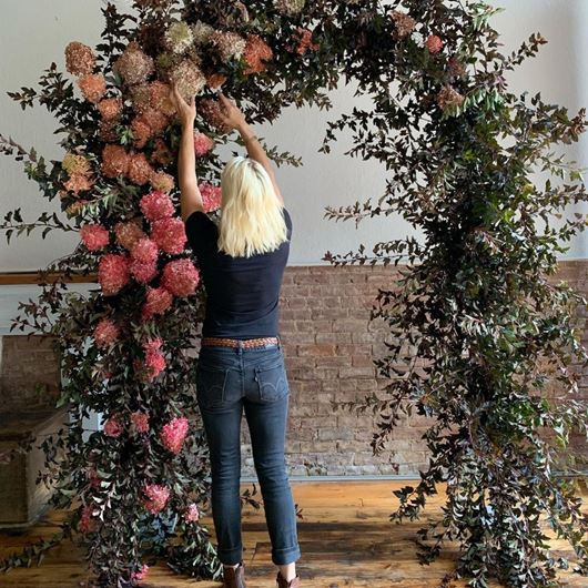 A summer arch made from foraged materials, by Caroline Eells.