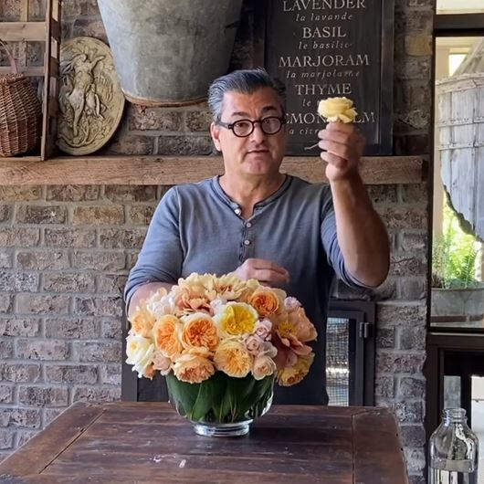 Charlie Groppetti demonstrates a garden-style arrangement using roses and peonies.