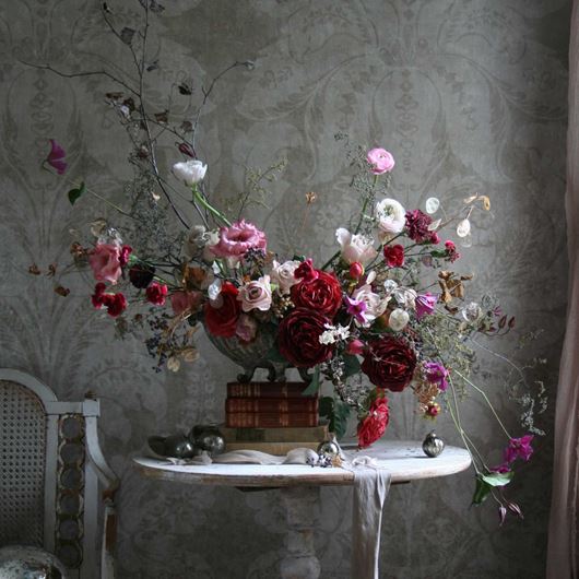 Assorted, cool-toned pink flowers add warmth to a seasonal arrangement.