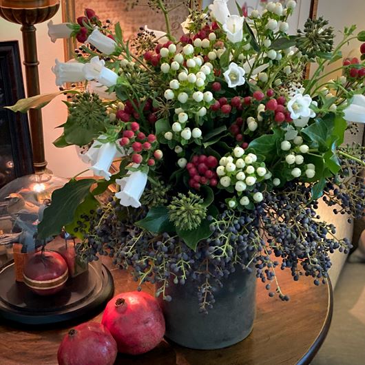 Holiday arrangement featuring juniper berries, Hypericum, Hedera berries and Campanula.