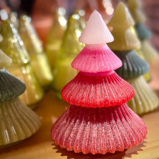 Pine tree shaped candles from Urban Outfitters make ideal canvases for a gradient of festive red and green shades.