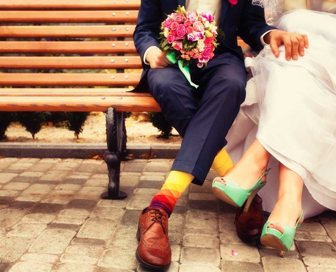 A just-married couple celebrates their nuptials with bright blooms.