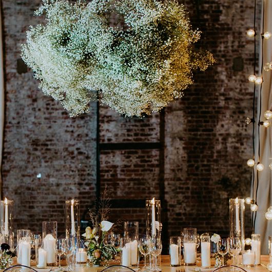 A dramatic chandelier of Gypsophila stems adds an airy feel to this elegant tablescape.