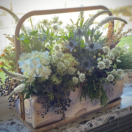 Veronica, Hydrandea, Eryngium and other fillers showcase subtle tonalities of green in this rustic display.