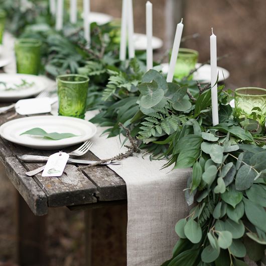 Rustic tablescape showcases the best of ornamental greenery, including 'Silver Dollar' Eucalyptus.