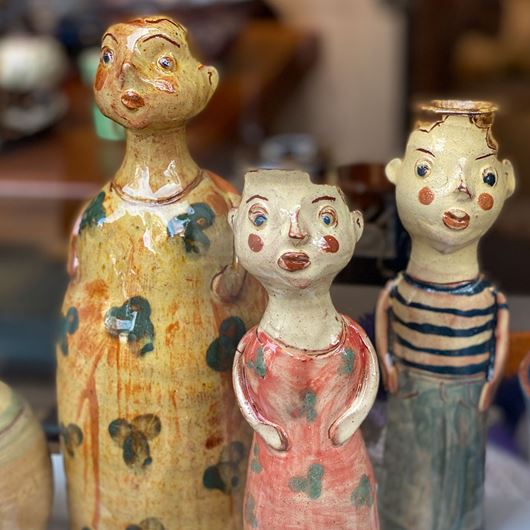 Ceramic figurines featuring UTILITARIAN's warm color palette.