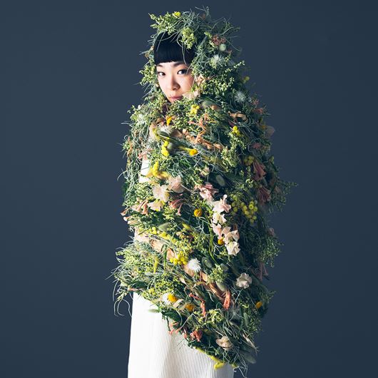 Floral cape ensemble featuring assorted blooms.