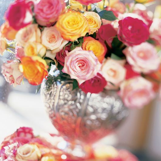 Assorted roses in vibrant colors are the showstoppers of this Valentine's Day centerpiece.