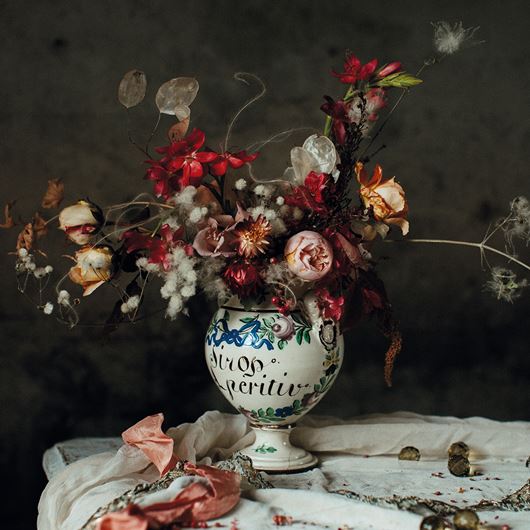 A beautiful winter bounty from Lucy's garden, featuring kaffir lilies, roses, pink pepperberries, old man's beard and lunaria seed heads.