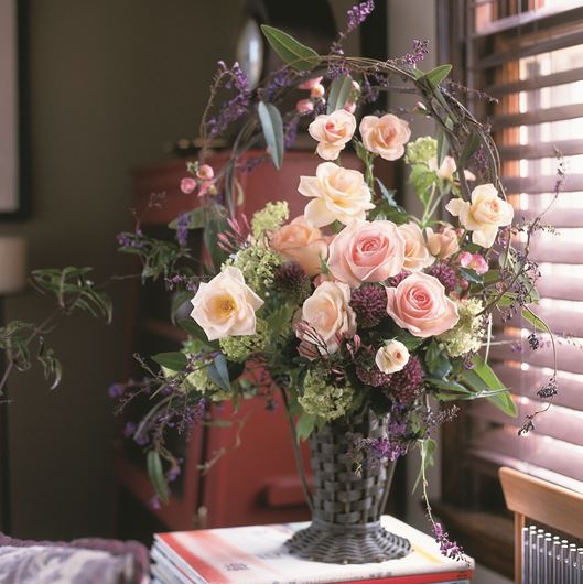Vintage Victorian "celebration" basket filled with roses, Alliums, Hydrangeas, and California jasmine vines