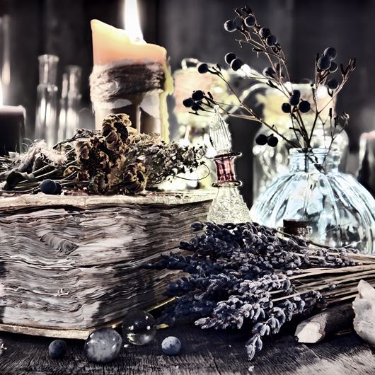 Halloween tablscape featuring dried flowers, candlight and antique books.