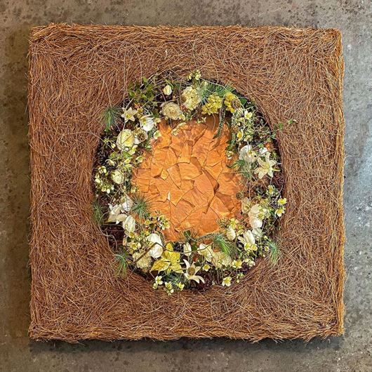 Modern Christmas wreath featuring dried flowers and grasses.