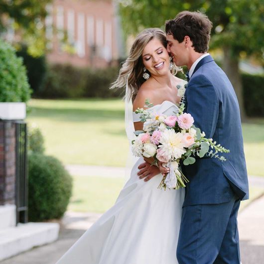 A couple celebrate their recent nuptials with blushing pastel blooms.