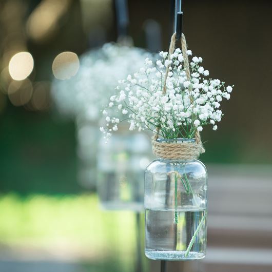 Simple outdoor decor featuring hanging vases with Gypsophila.