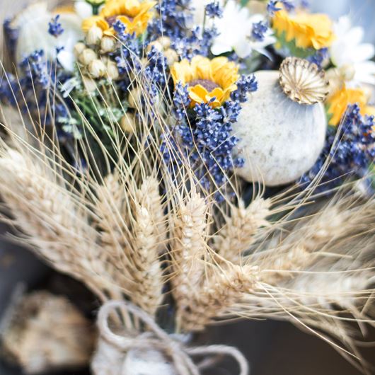 Vintage-style wedding bouquet, featuring dried sunflowers, lavender, poppy heads and wheat.