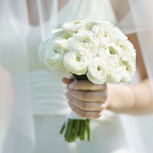 Bridal bouquet featuring white Ranunculus.