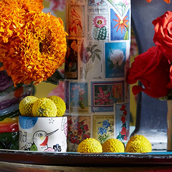 Whimsical Craspedia blooms decorate a camp-inspired tablescape with ease.
